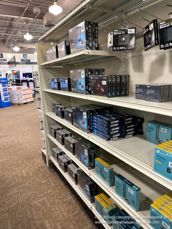 shelves of electronics on shelves in a store