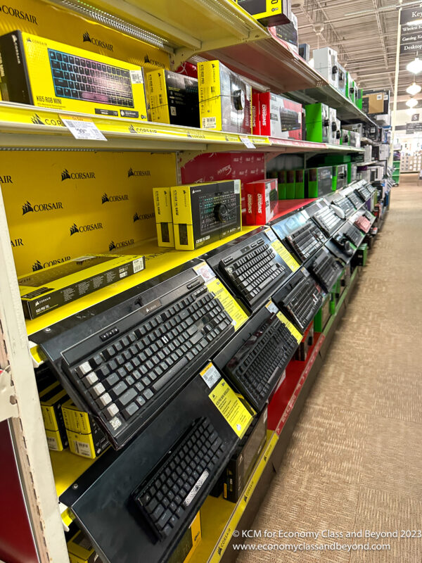 a shelf with many keyboards