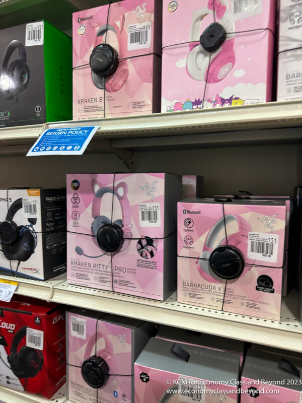 a shelf with boxes of headphones