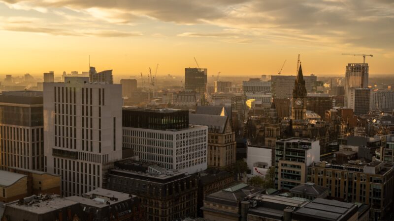 a city with many buildings and cranes