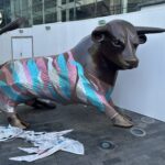 a statue of a bull with a colorful wrap around it
