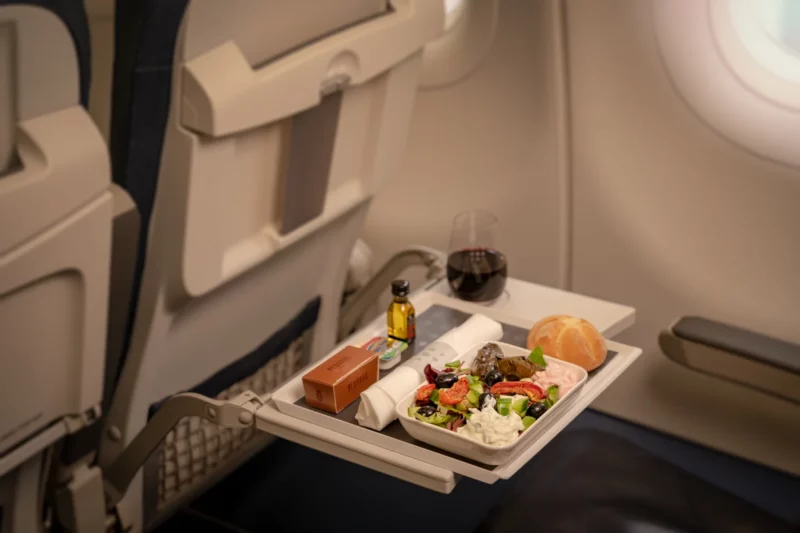 a tray of food on a table in an airplane