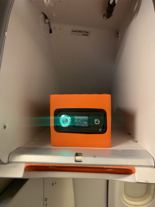 an orange box with a green light on it
