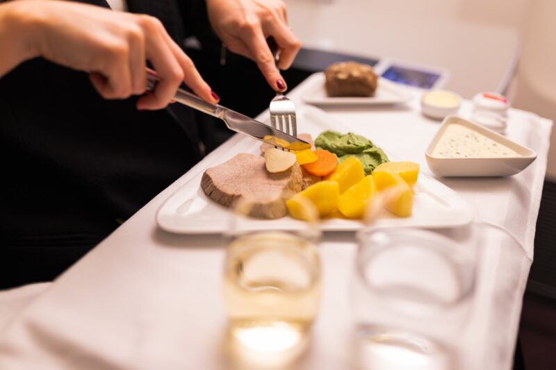 a person cutting food on a plate