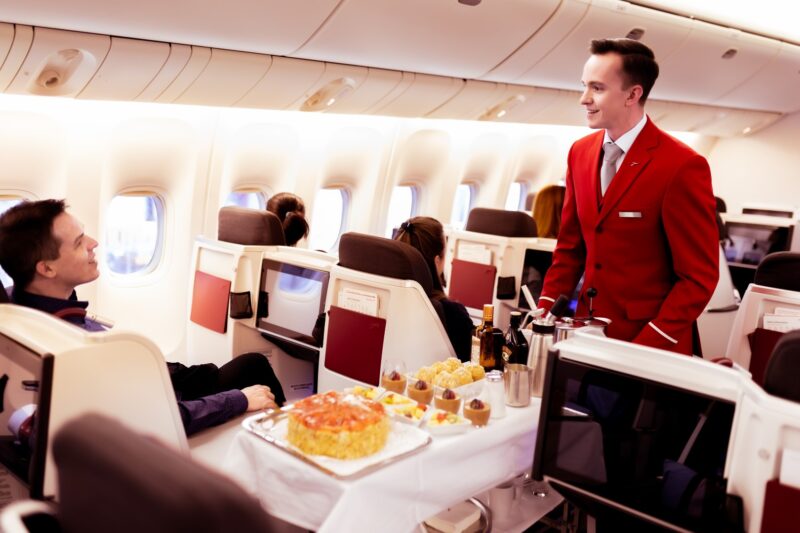 a man in a red suit standing in a plane