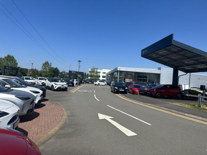 a parking lot with cars and a building