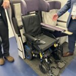 a man standing next to a wheelchair
