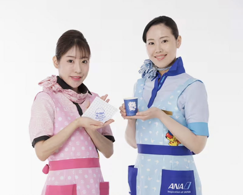 a couple of women wearing aprons holding cups and papers