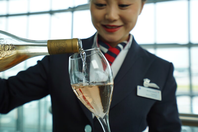 a woman pouring a wine into a glass