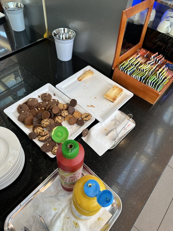 a plate of cookies and a bottle of condiments on a counter