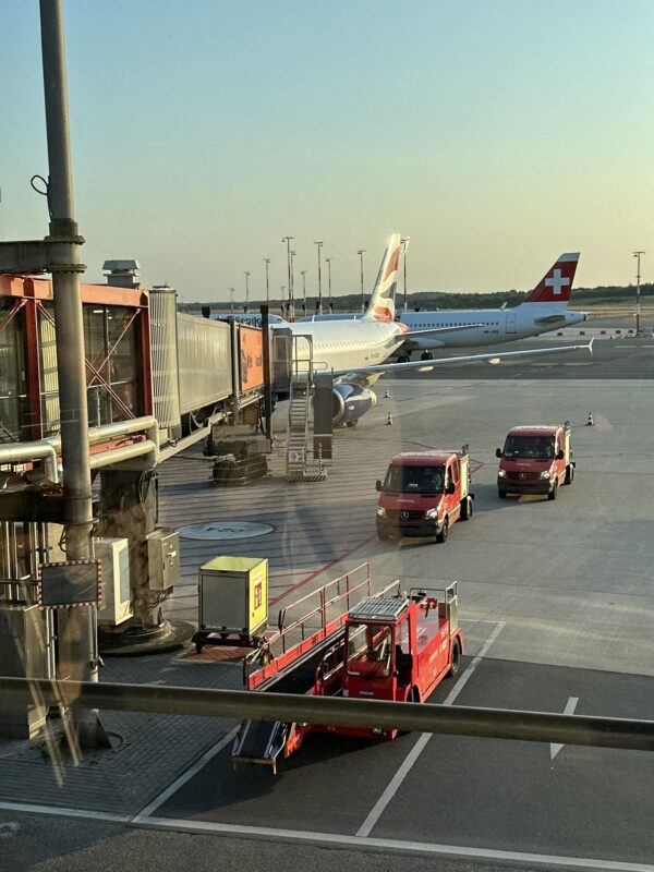 a plane and trucks at an airport