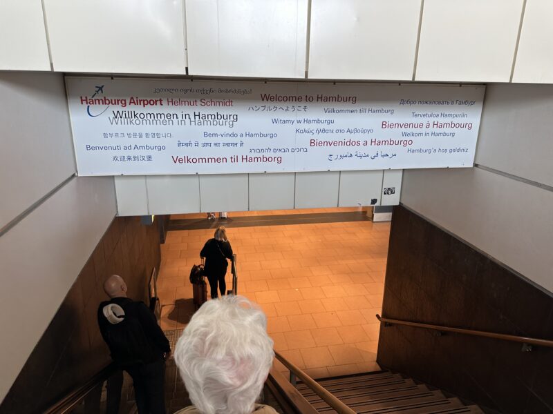 a person walking down a staircase with a sign above