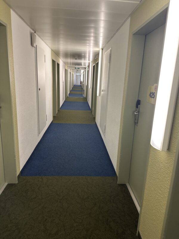 a hallway with doors and a door on the floor