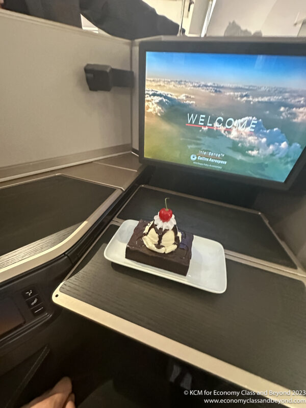 a piece of cake on a plate in front of a television