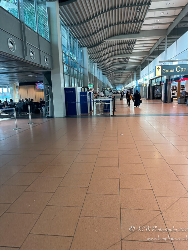 a large airport terminal with people walking