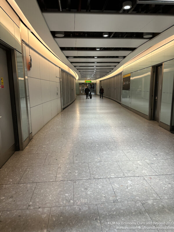 a hallway with people walking in the middle