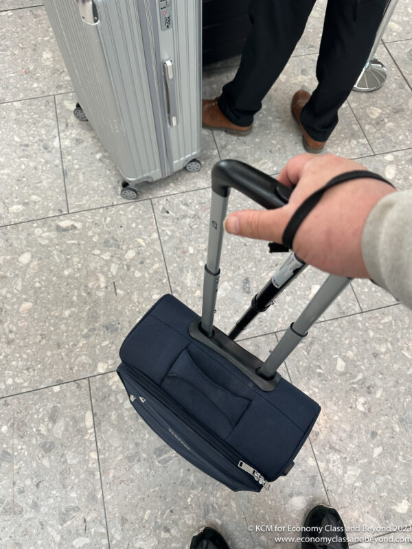 a hand holding a suitcase