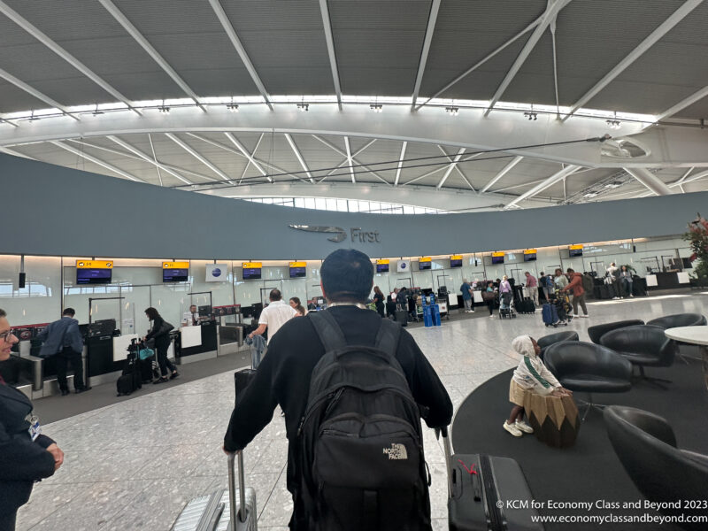 a man with a backpack walking in an airport