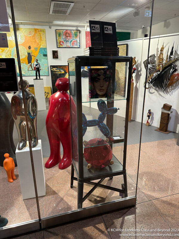 a display case with a red sculpture and a red statue