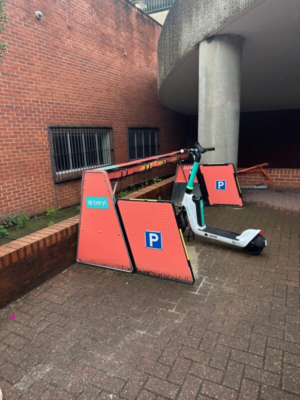 a scooter parked next to a parking lot