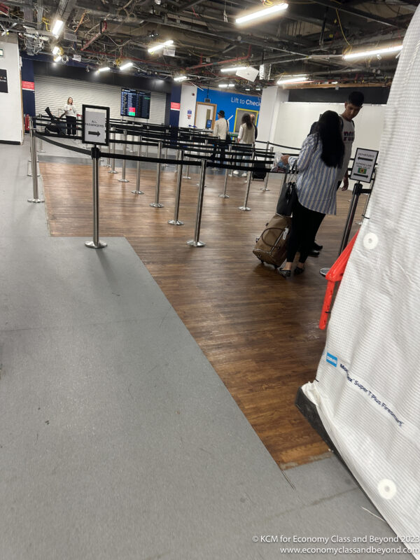 a man and woman with luggage in an airport