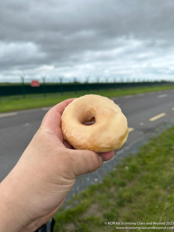 a hand holding a donut