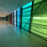 a long hallway with colorful glass panels