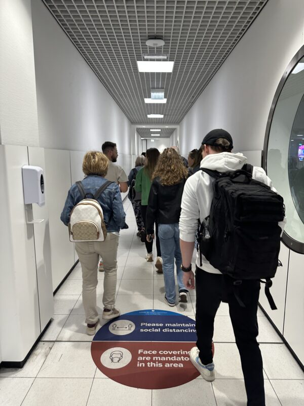 a group of people walking in a hallway