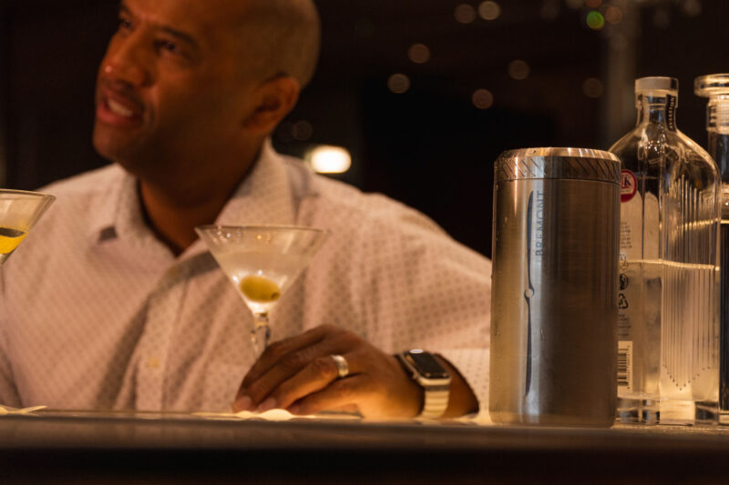 a man sitting at a table with a martini glass