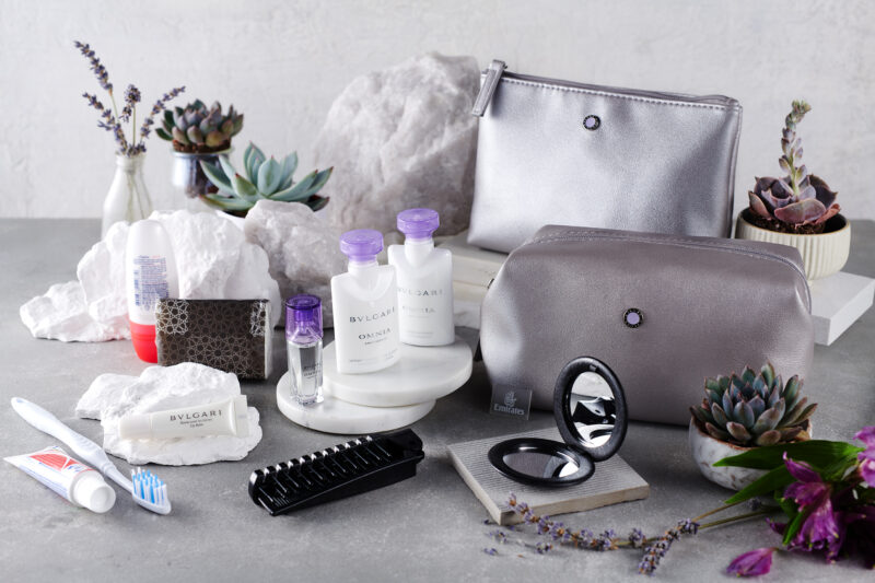 a group of cosmetics and a purse