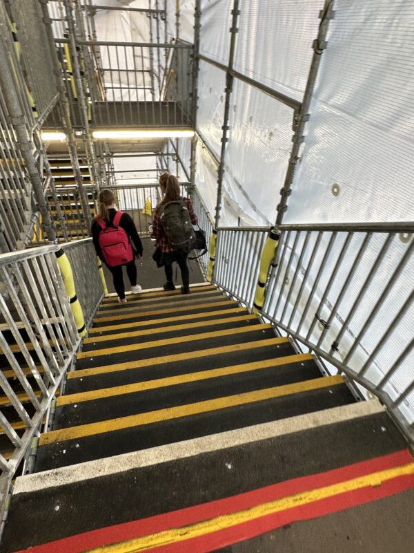 two girls walking up stairs