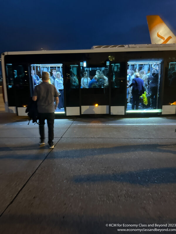 a man walking towards a bus