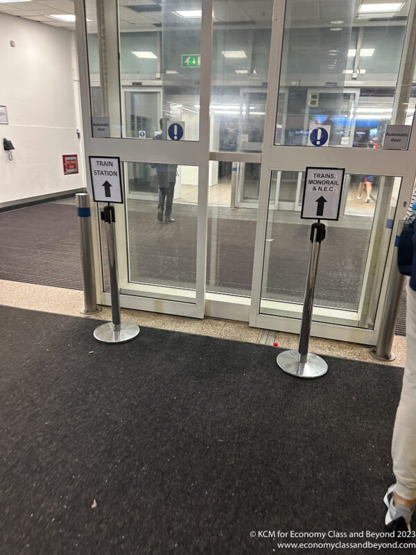 a door with glass doors and signs