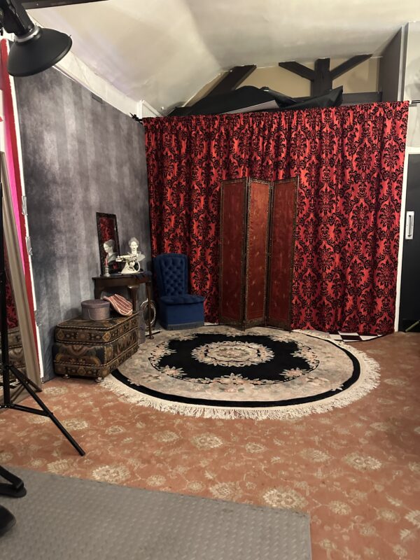 a room with red curtains and a black rug