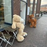 a two stuffed bears on a sidewalk