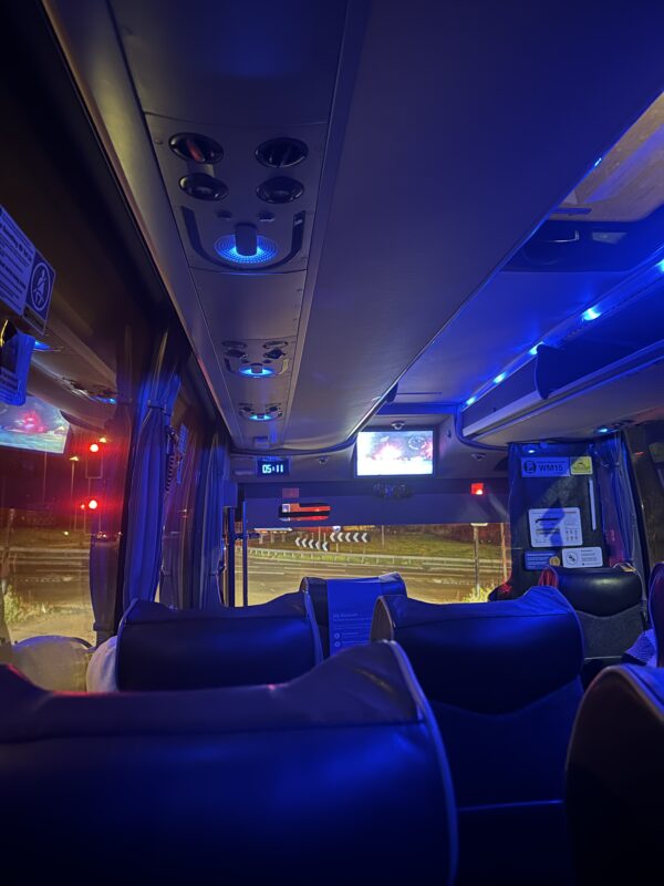 inside a bus with seats and lights
