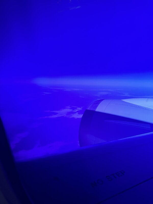 a plane wing with a blue background