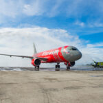 a red airplane on a runway