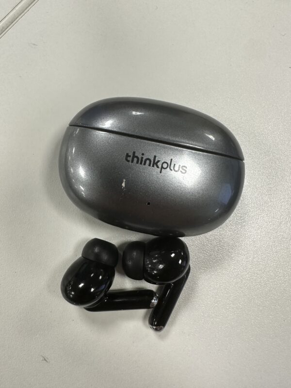 a black earbuds on a white surface