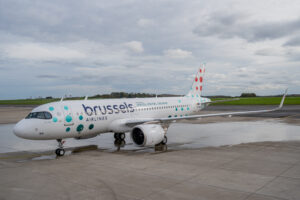 a white airplane with blue and red dots on it