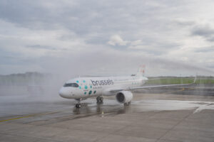 a white airplane on a wet runway