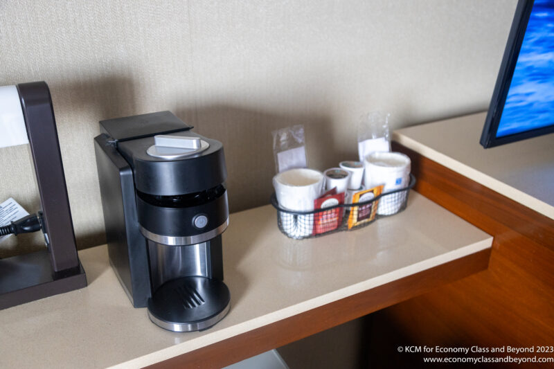 a coffee maker and coffee cups on a counter