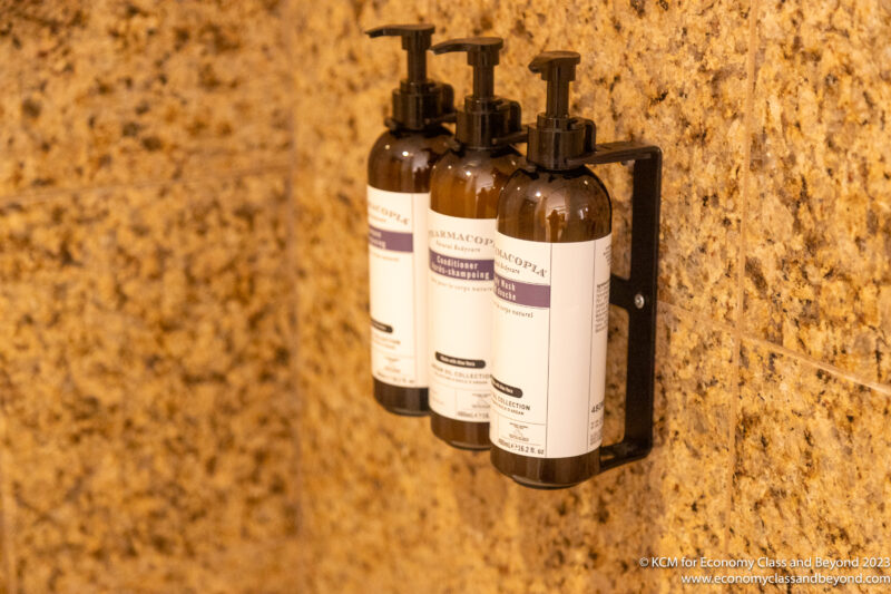 a group of bottles of liquid soap on a wall