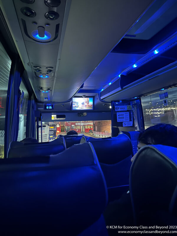 inside a bus with a view of the road from the back