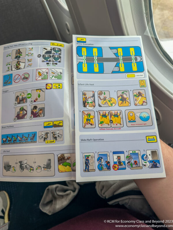 a person holding an airplane instruction booklet