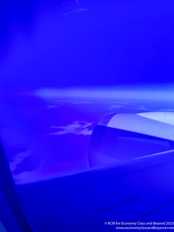 a plane's wing with a light coming out of it