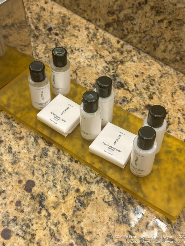 a group of small bottles of shampoo and soap on a counter