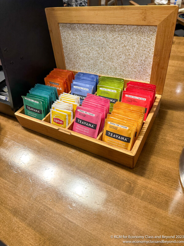 a wooden box with different colored packets