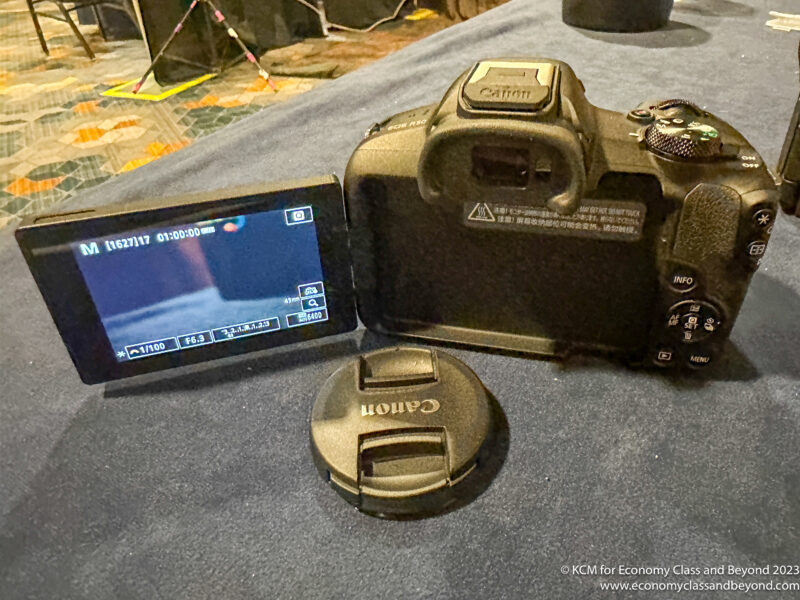 a camera with a screen and a lens cap