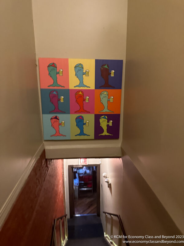 a hallway with a painting on the wall